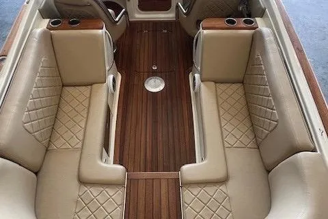 Slide: The Image of Luxurious interior of 2014 Chris-Craft Corsair 25 with tan leather seating and wood flooring. - 14