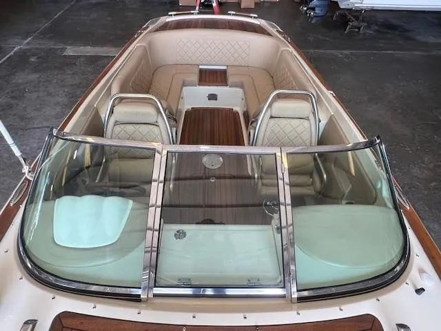 Slide: The Image of 2014 Chris-Craft Corsair 25 boat interior with elegant seating and wood accents. - 17