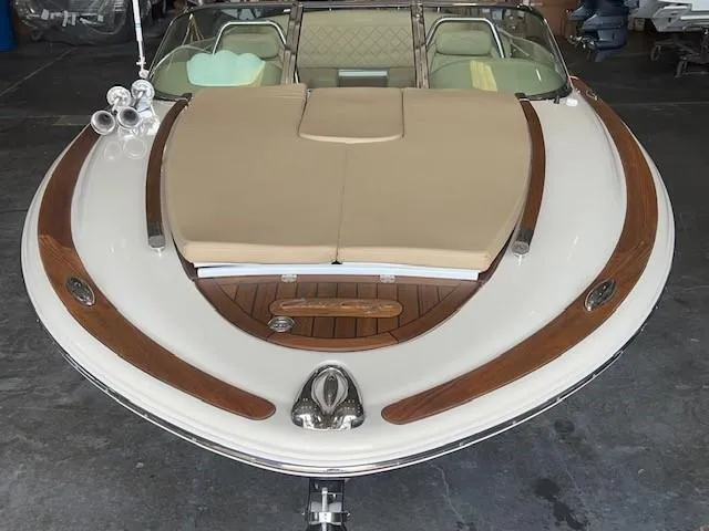 Slide: The Image of 2014 Chris-Craft Corsair 25 boat with elegant wood accents and beige upholstery. - 19
