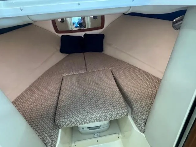 Slide: The Image of Interior cabin of 2014 Chris-Craft Corsair 25 with cushioned seating and pillows. - 20