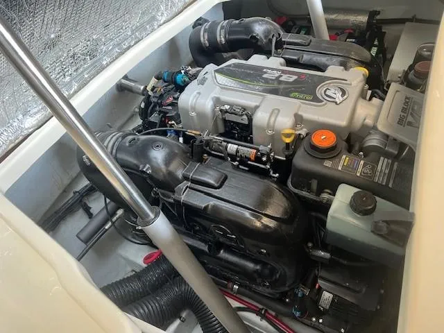 Slide: The Image of 2014 Chris-Craft Corsair 25 engine compartment, showcasing a powerful inboard motor. - 23
