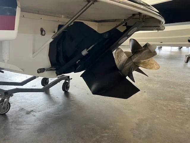 Slide: The Image of 2014 Chris-Craft Corsair 25 boat propeller and stern detail in a garage. - 5