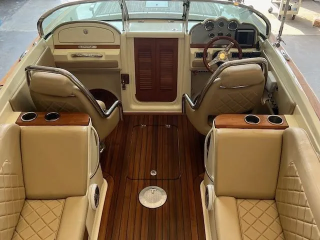 Slide: The Image of Luxurious 2014 Chris-Craft Corsair 25 boat interior with leather seats and wooden flooring. - 7