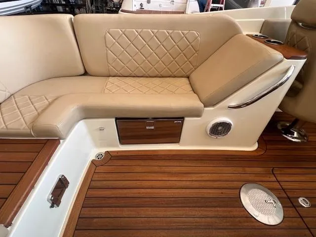 Slide: The Image of Luxurious interior of 2014 Chris-Craft Corsair 25 with tan leather seating and wooden flooring. - 8