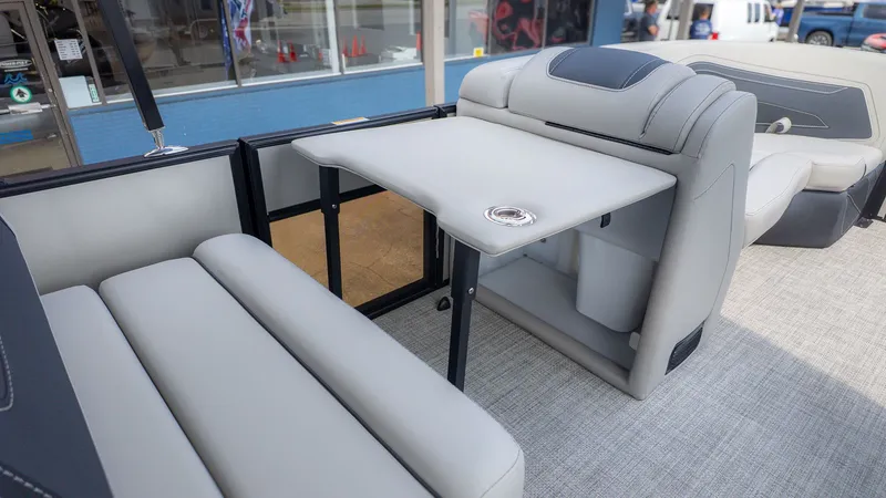 Slide: The Image of Interior of 2026 Barletta Cabrio 24UE with gray seating and table. - 14