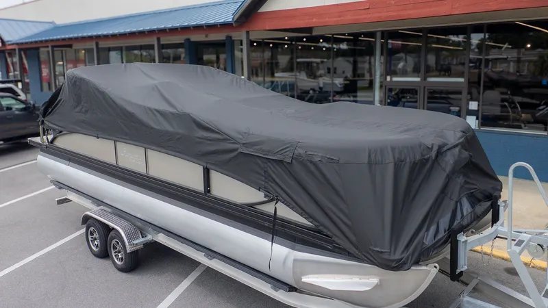 Slide: The Image of 2026 Barletta Cabrio 24UE pontoon boat covered on trailer. - 2