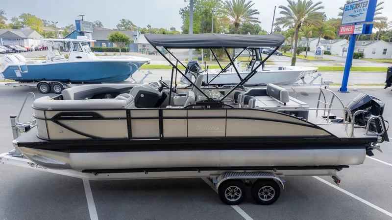 Slide: The Image of 2026 Barletta Cabrio 24UE pontoon boat on trailer outdoors. - 4