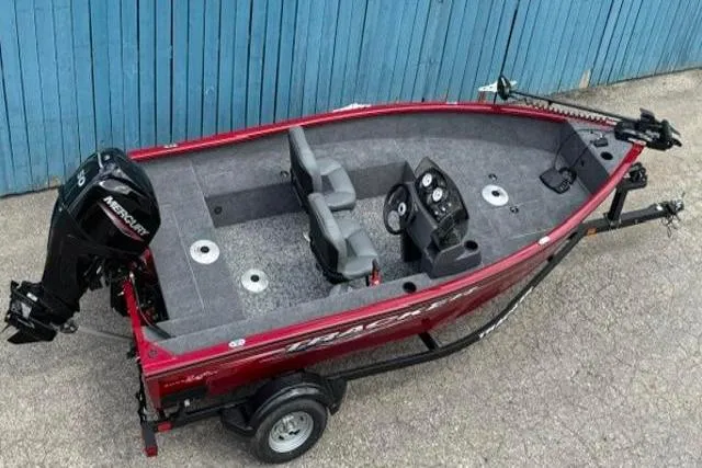 Slide: The Image of 2025 Tracker Super Guide V-16 SC fishing boat with Mercury engine, parked on trailer. - 4