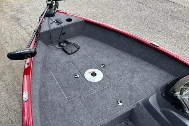 Slide: The Image of 2025 Tracker Super Guide V-16 SC boat interior with carpeted deck and trolling motor. - 6