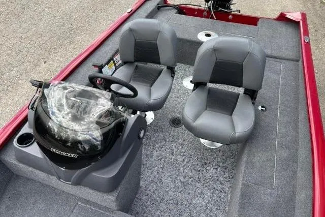 Slide: The Image of 2025 Tracker Super Guide V-16 SC boat interior with dual gray seats and steering console. - 8