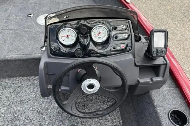 Slide: The Image of 2025 Tracker Super Guide V-16 SC boat dashboard with steering wheel and gauges. - 9