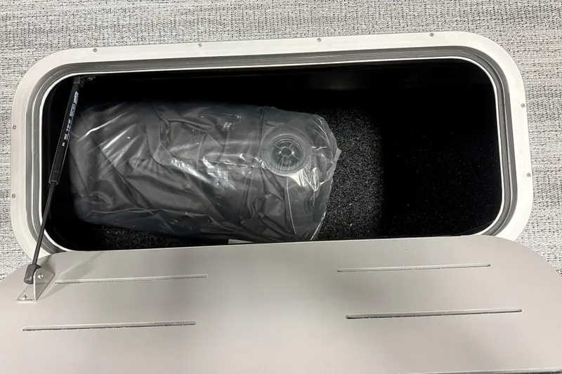 Slide: The Image of Storage compartment in 2026 Bennington 22 S Swingback boat, containing a wrapped item. - 14
