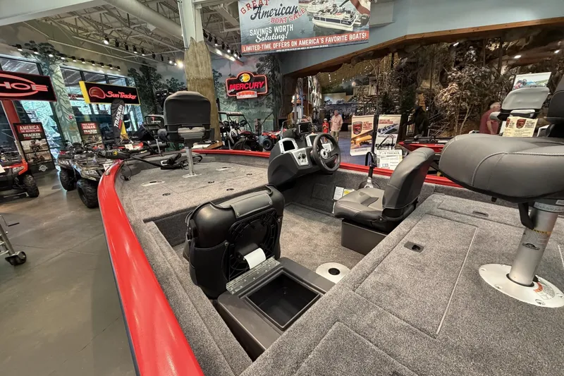 Slide: The Image of 2026 Tracker Pro Team 175 Crappie Edition boat displayed in showroom with fishing seats. - 7