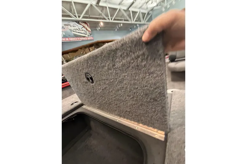 Slide: The Image of 2026 Tracker Pro Team 175 Crappie Edition boat storage compartment being opened. - 9
