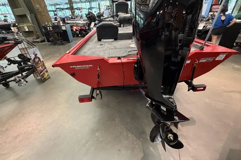 Slide: The Image of 2026 Tracker Pro Team 175 Crappie Edition boat displayed indoors, featuring a red exterior and motor. - 4