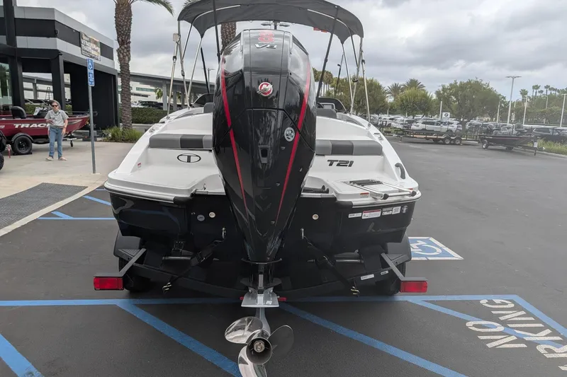 Slide: The Image of 2026 Tahoe T21 boat with outboard motor in a parking lot. - 3