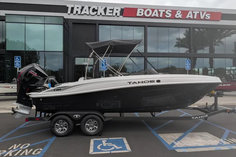 Slide: The Image of 2026 Tahoe T21 boat on trailer at Tracker Boats dealership. - 4