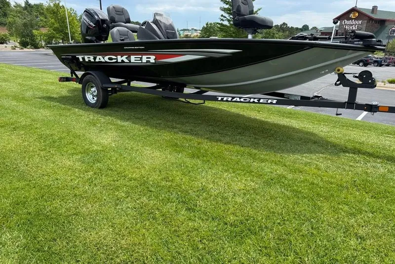 Slide: The Image of 2026 Tracker Pro Team 175 Crappie Edition boat on trailer, parked on grass. - 2