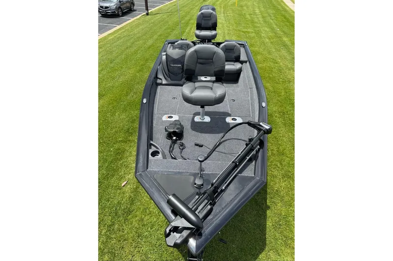 Slide: The Image of 2026 Tracker Pro Team 175 Crappie Edition boat on grass, featuring seating and fishing equipment. - 7