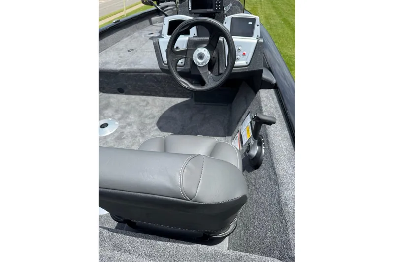 Slide: The Image of 2026 Tracker Pro Team 175 Crappie Edition boat interior with steering wheel and seating. - 9