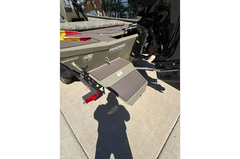 Slide: The Image of 2026 Tracker Grizzly 1860 CC boat rear view with motor and step ladder. - 14