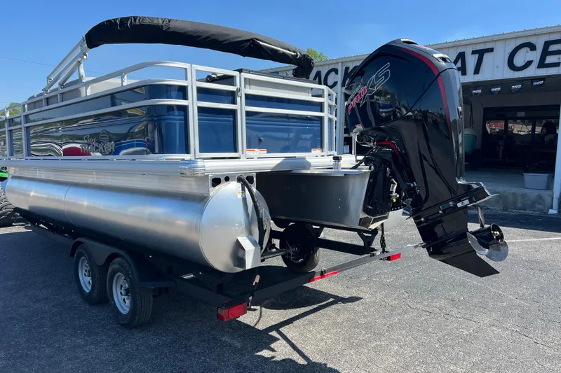 Slide: The Image of 2026 Sun Tracker SportFish 20 DLX pontoon boat with powerful outboard motor on trailer. - 2