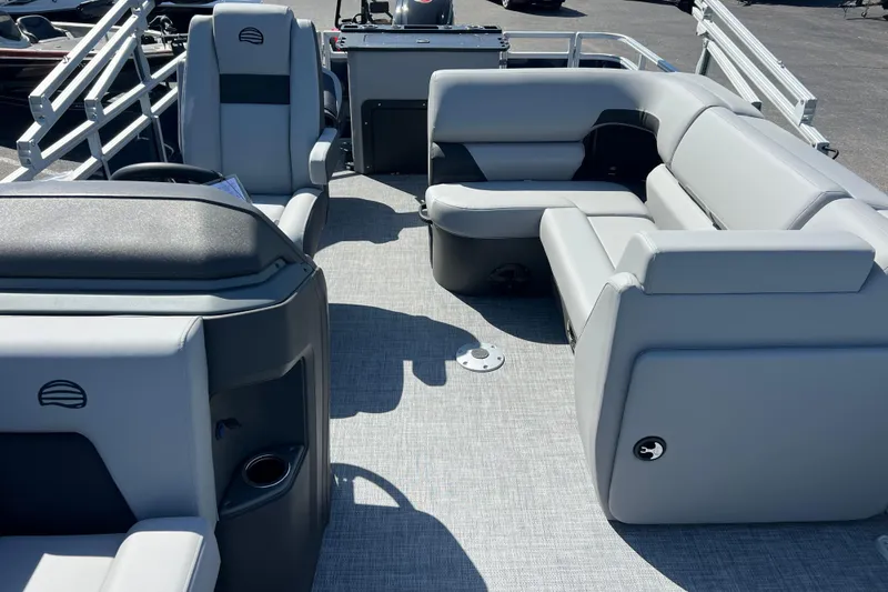 Slide: The Image of 2026 Sun Tracker SportFish 20 DLX pontoon boat interior with gray seating and helm. - 5