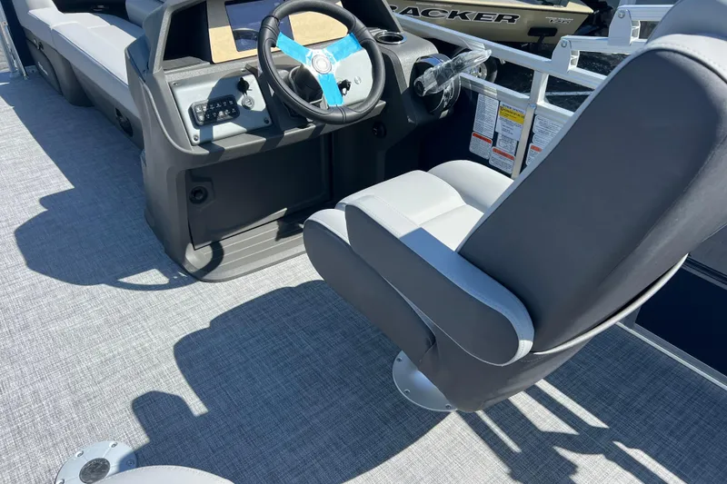 Slide: The Image of 2026 Sun Tracker SportFish 20 DLX boat interior with steering wheel and seating. - 7