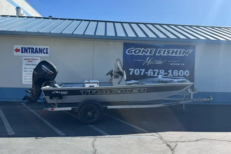 The Image of 2026 Tracker Bass Tracker Classic CC boat parked outside Gone Fishin' Marine store. - 2