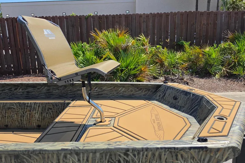 Slide: The Image of 2026 Tracker Grizzly 1650 T Prairie Wings Edition boat with camo design and swivel seat. - 8
