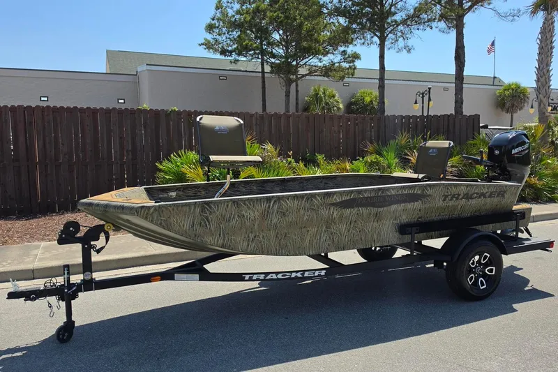 Slide: The Image of 2026 Tracker Grizzly 1650 T Prairie Wings Edition boat on trailer, outdoors. - 5