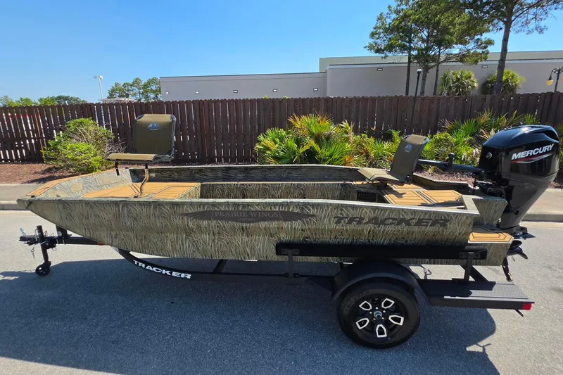 Slide: The Image of 2026 Tracker Grizzly 1650 T Prairie Wings Edition boat with Mercury engine on trailer. - 6