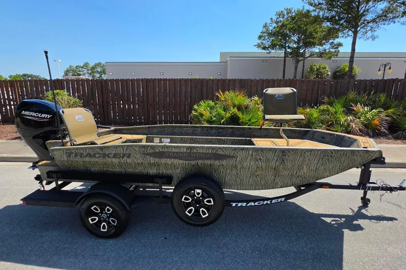 The Image of 2026 Tracker Grizzly 1650 T Prairie Wings Edition boat on trailer, featuring Mercury engine. - 0