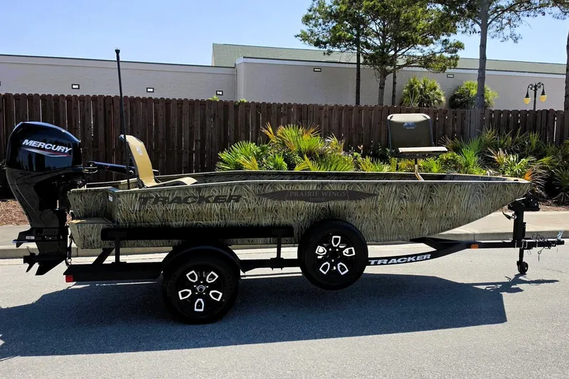 Slide: The Image of 2026 Tracker Grizzly 1650 T Prairie Wings Edition boat on trailer, outdoors. - 3