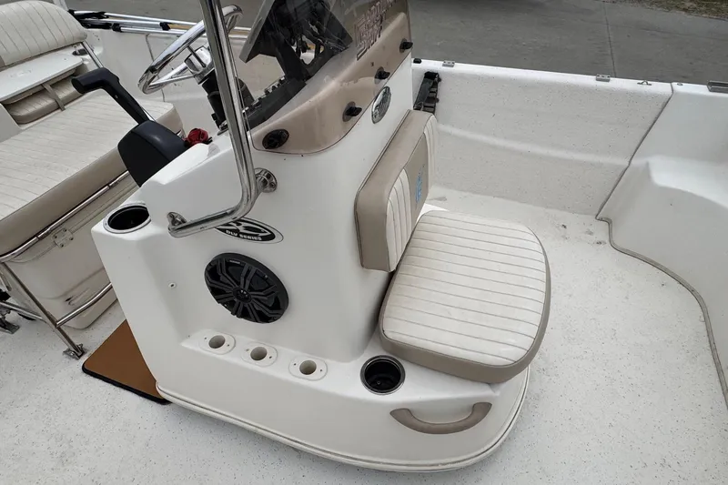 Slide: The Image of Interior view of a 2016 Carolina Skiff 218 DLV boat with helm console. - 11