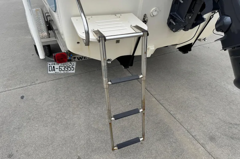 Slide: The Image of 2016 Carolina Skiff 218 DLV with retractable swim ladder. - 18
