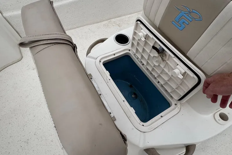 Slide: The Image of 2016 Carolina Skiff 218 DLV boat with open storage compartment. - 20
