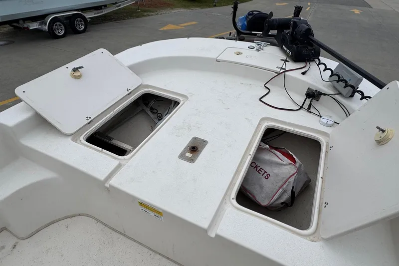 Slide: The Image of 2016 Carolina Skiff 218 DLV boat with open storage compartments. - 22