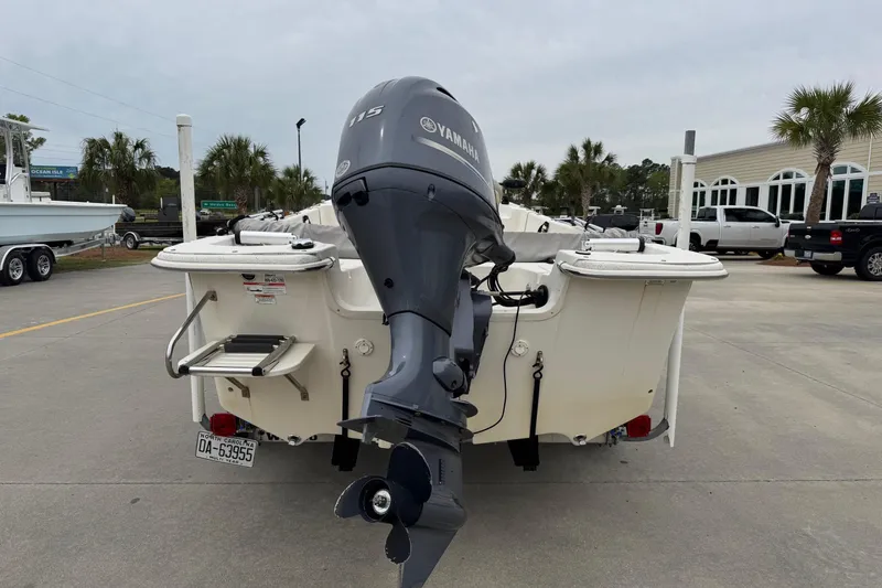 Slide: The Image of 2016 Carolina Skiff 218 DLV with Yamaha motor on parking lot. - 4