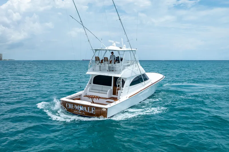 Slide: The Image of 2026 Viking 54 Convertible yacht cruising on open ocean waters. - 10