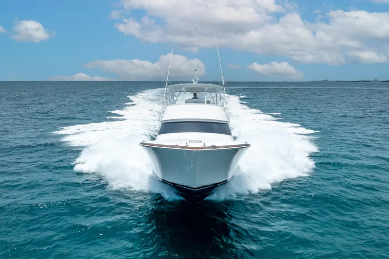 Slide: The Image of 2026 Viking 54 Convertible yacht cruising on open ocean under blue sky. - 16