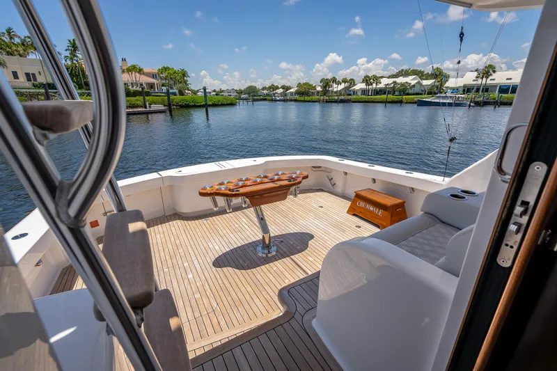 Slide: The Image of Luxurious deck of 2026 Viking 54 Convertible yacht with scenic waterfront view. - 22