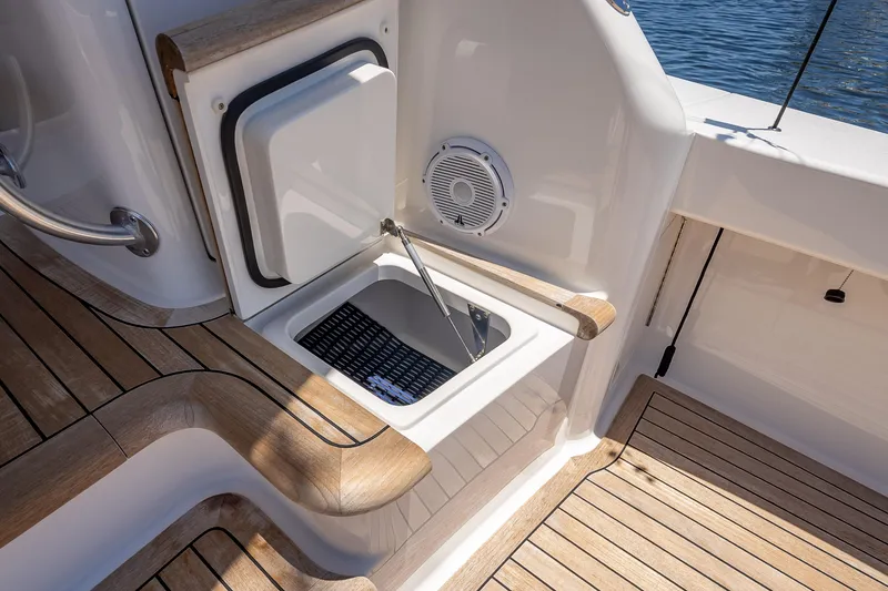 Slide: The Image of 2026 Viking 54 Convertible yacht deck with storage compartment and speaker. - 25