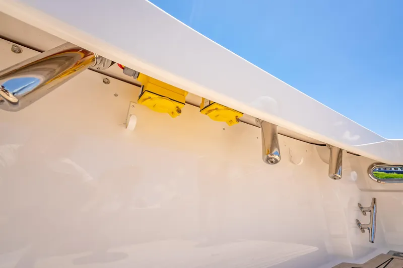 Slide: The Image of Viking 54 Convertible 2026 yacht deck detail with rod holders and bright yellow fixtures. - 26