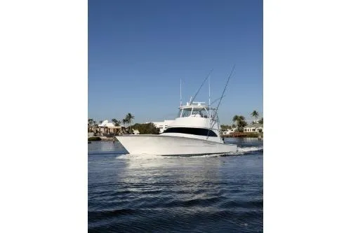 Slide: The Image of 2026 Viking 54 Convertible yacht cruising on calm waters under clear blue skies. - 3
