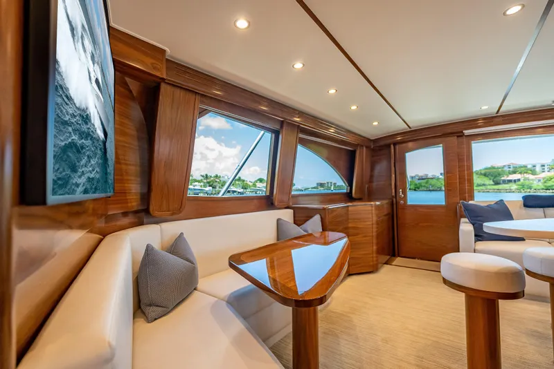 Slide: The Image of Luxurious interior of 2026 Viking 54 Convertible yacht with elegant wood finishes and plush seating. - 32