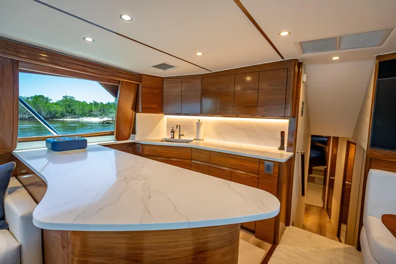 Slide: The Image of Luxurious interior of 2026 Viking 54 Convertible yacht with modern kitchen design. - 37