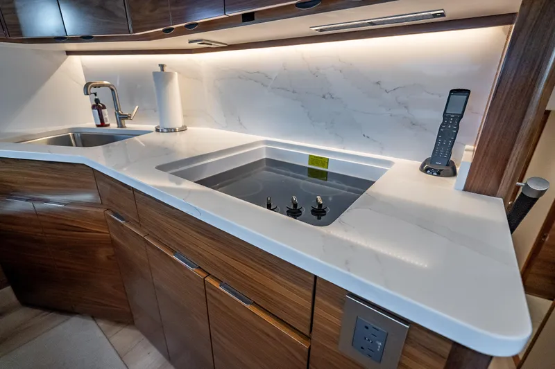 Slide: The Image of Modern kitchen in 2026 Viking 54 Convertible yacht with sleek countertops and appliances. - 39