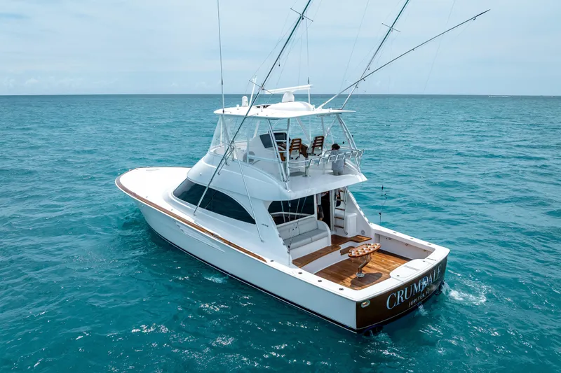 Slide: The Image of 2026 Viking 54 Convertible yacht cruising on open ocean waters. - 4