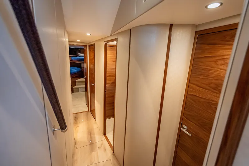Slide: The Image of Interior hallway of 2026 Viking 54 Convertible yacht with wooden doors and modern lighting. - 40
